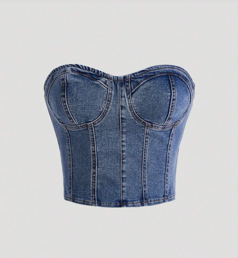 Corset jeans estruturado com cinco recortes verticais e bojo anatômico, tecido com lavagem estonada, costuras visíveis e acabamento fosco. Perfeito para valorizar a cintura com elegância urbana.